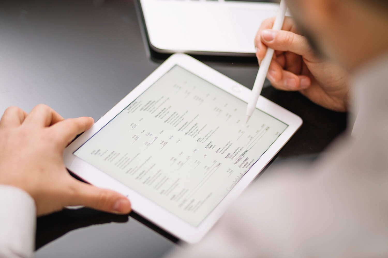 A person working on his iPad